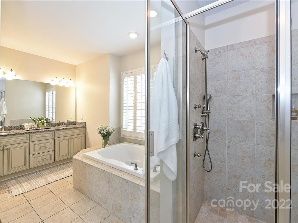 801 Sedgefield Road Charlotte, NC 28209 - Photo 15 of 30 a bathroom with a granite countertop tub sink shower and mirror