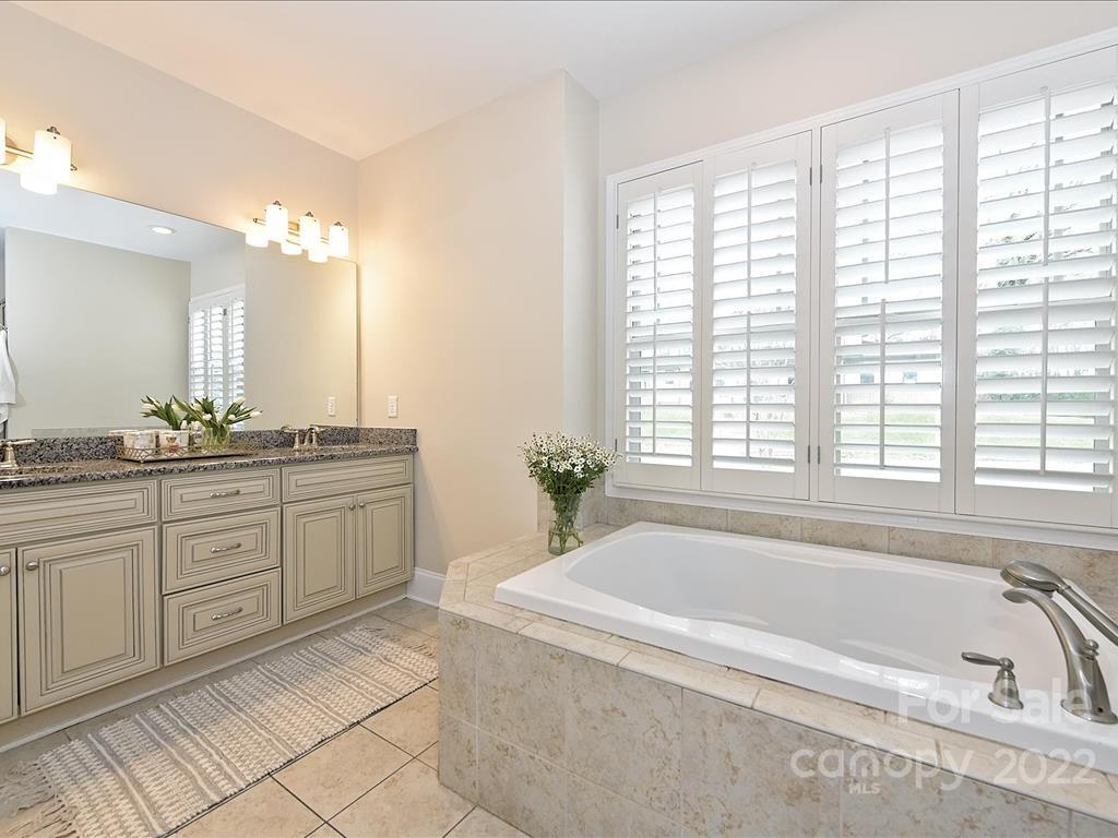 801 Sedgefield Road Charlotte, NC 28209 - Photo 16 of 30 a spacious bathroom with a tub sink and mirror