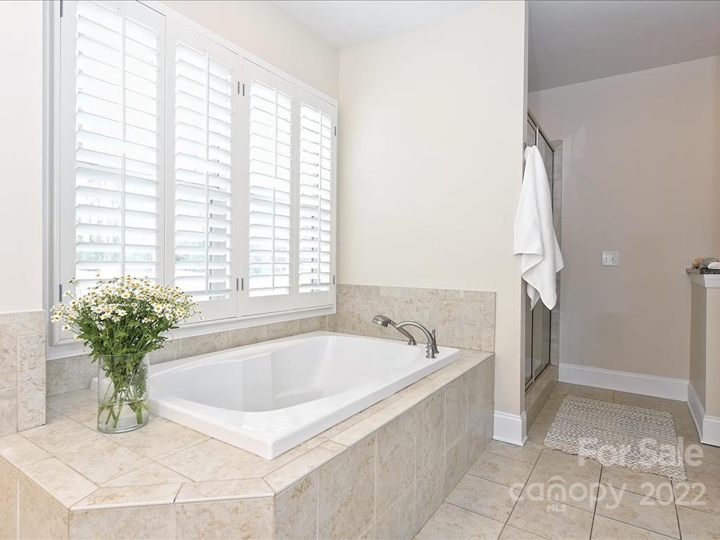 801 Sedgefield Road Charlotte, NC 28209 - Photo 17 of 30 a white bath tub sitting in a bathroom next to a window