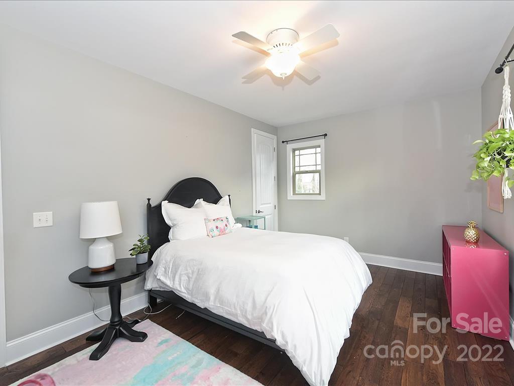 801 Sedgefield Road Charlotte, NC 28209 - Photo 19 of 30 a bedroom with a bed and a potted plant