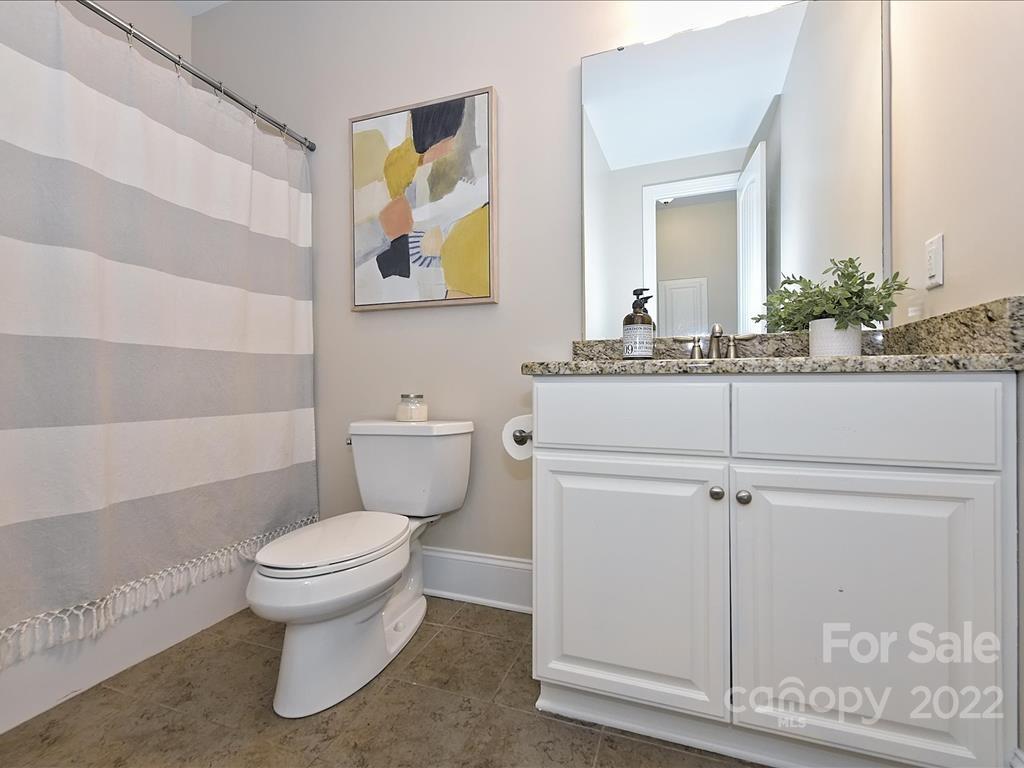 801 Sedgefield Road Charlotte, NC 28209 - Photo 20 of 30 a bathroom with a sink a toilet and mirror