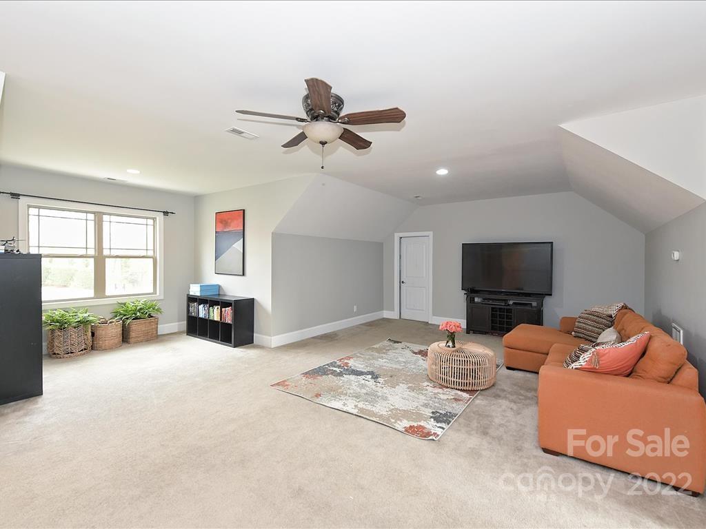 801 Sedgefield Road Charlotte, NC 28209 - Photo 22 of 30 a living room with furniture a flat screen tv and a fireplace