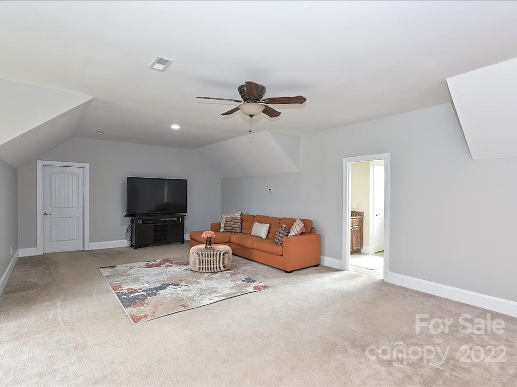 801 Sedgefield Road Charlotte, NC 28209 - Photo 23 of 30 a living room with furniture a flat screen tv and a ceiling fan