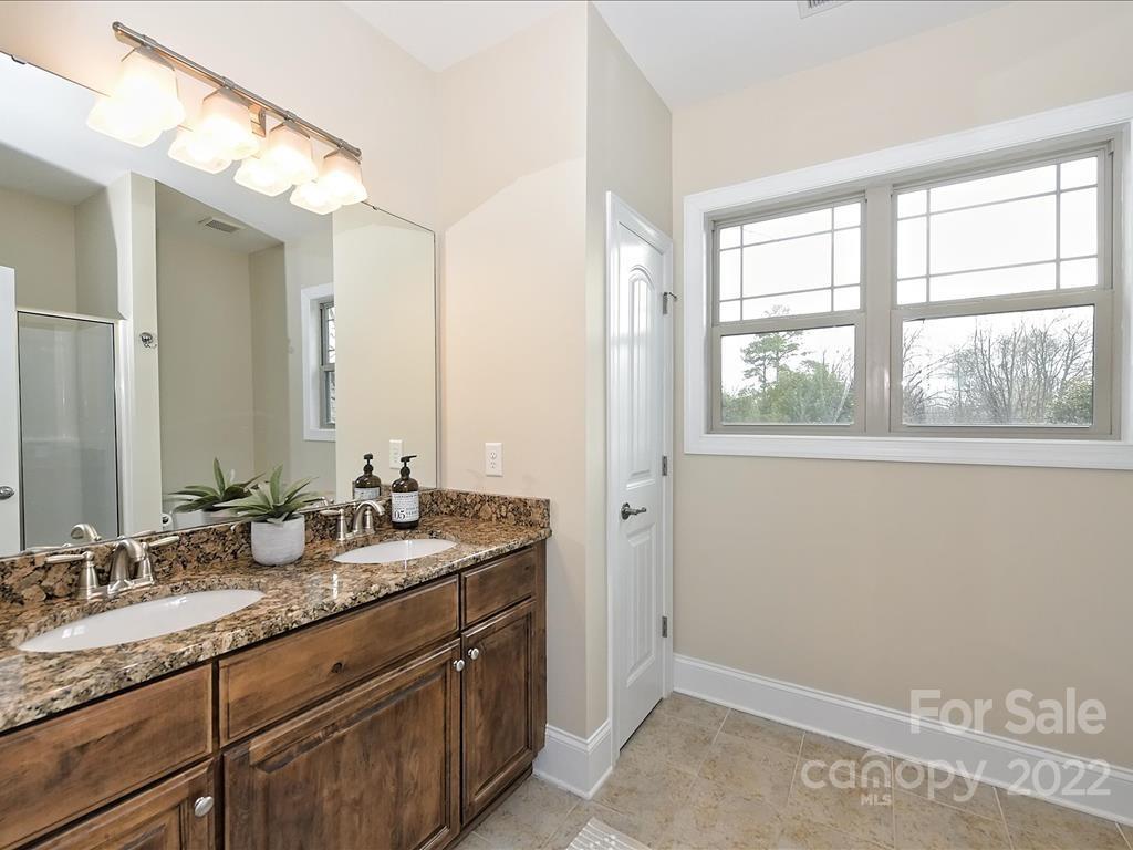 801 Sedgefield Road Charlotte, NC 28209 - Photo 26 of 30 a bathroom with a granite countertop sink and a mirror