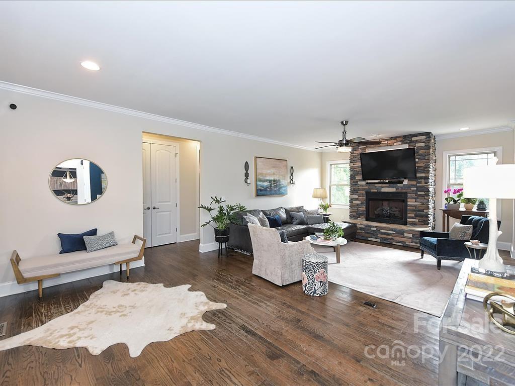 801 Sedgefield Road Charlotte, NC 28209 - Photo 5 of 30 a living room with furniture a fireplace and a flat screen tv