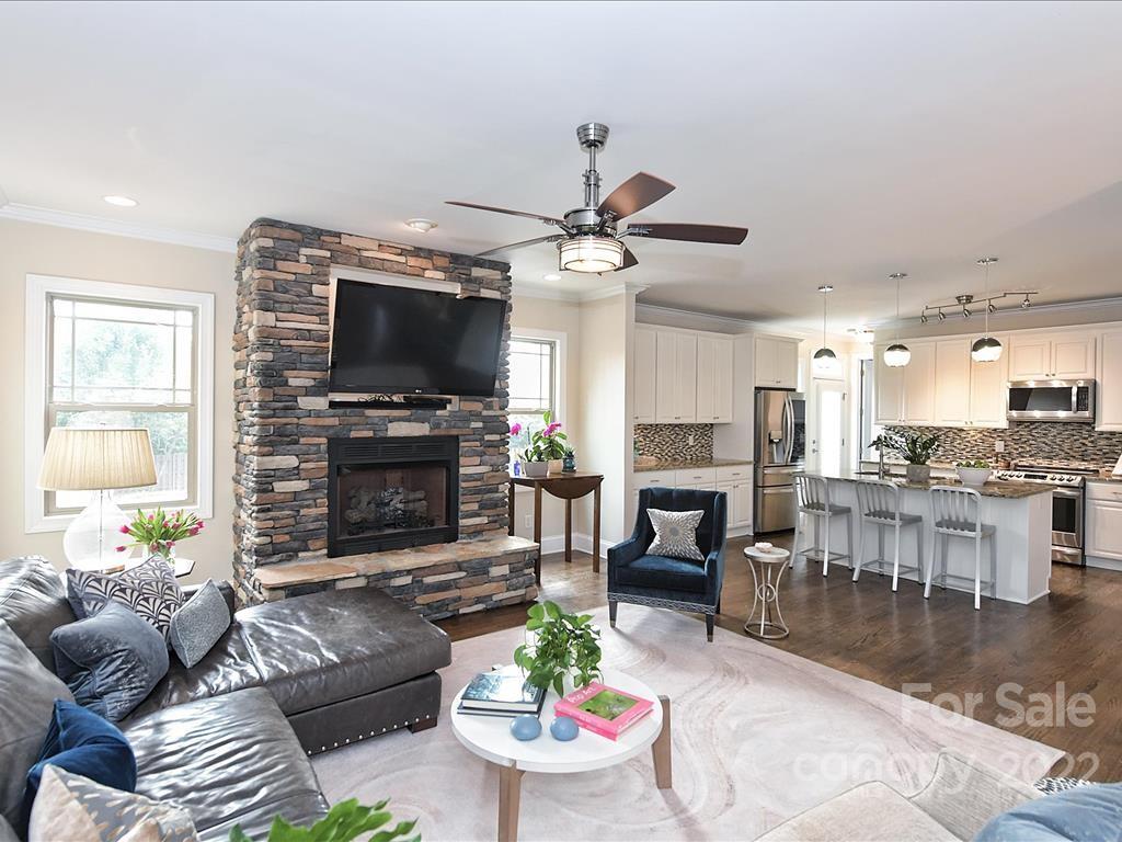 801 Sedgefield Road Charlotte, NC 28209 - Photo 6 of 30 a living room with furniture a fireplace and a flat screen tv