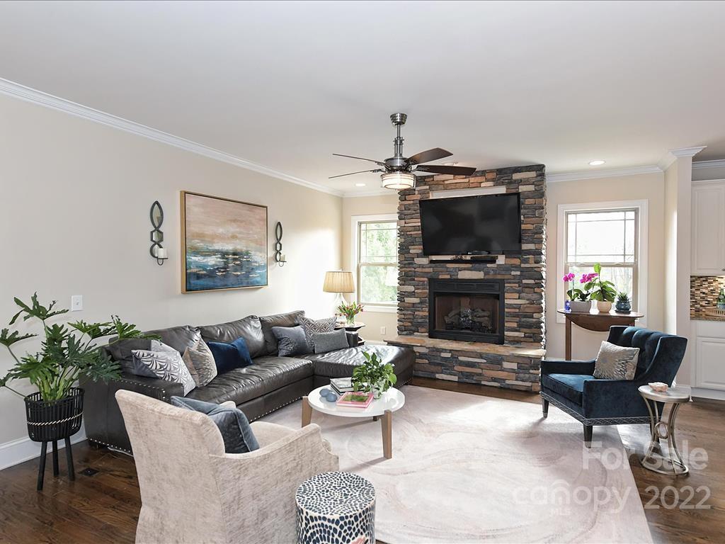 801 Sedgefield Road Charlotte, NC 28209 - Photo 8 of 30 a living room with furniture a fireplace and a flat screen tv