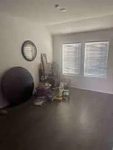 a room with a chair and a large window