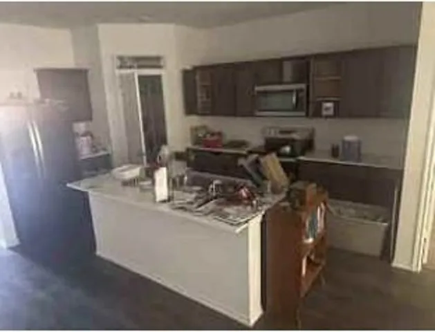 a kitchen with stainless steel appliances granite countertop a sink stove and microwave