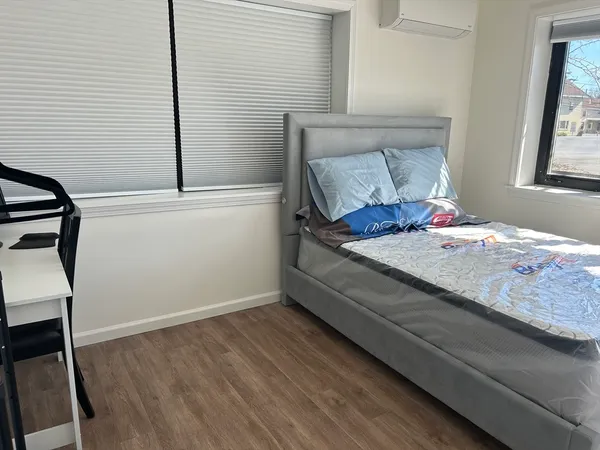 a bedroom with a bed and a window