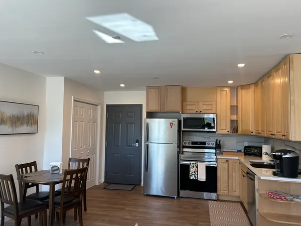 a kitchen with stainless steel appliances a refrigerator stove microwave and cabinets