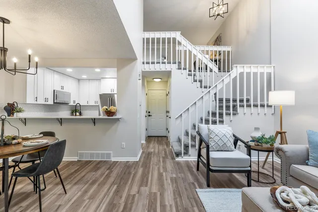 a view of a dining room with furniture wooden floor and a chandelier