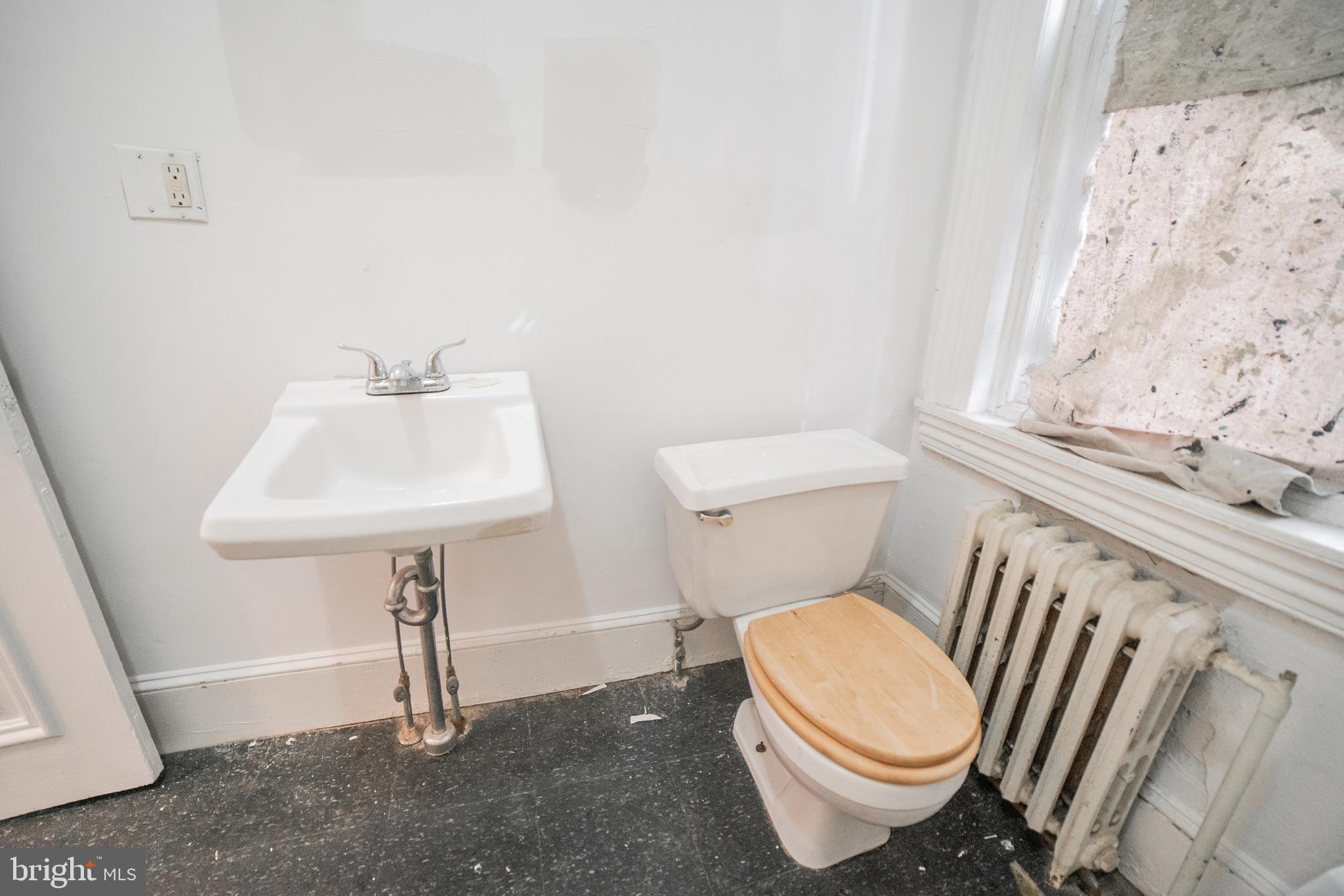2316 Spruce Street, Unit 2R Philadelphia, PA 19103 - Photo 11 of 11 a white toilet sitting next to a bathroom sink