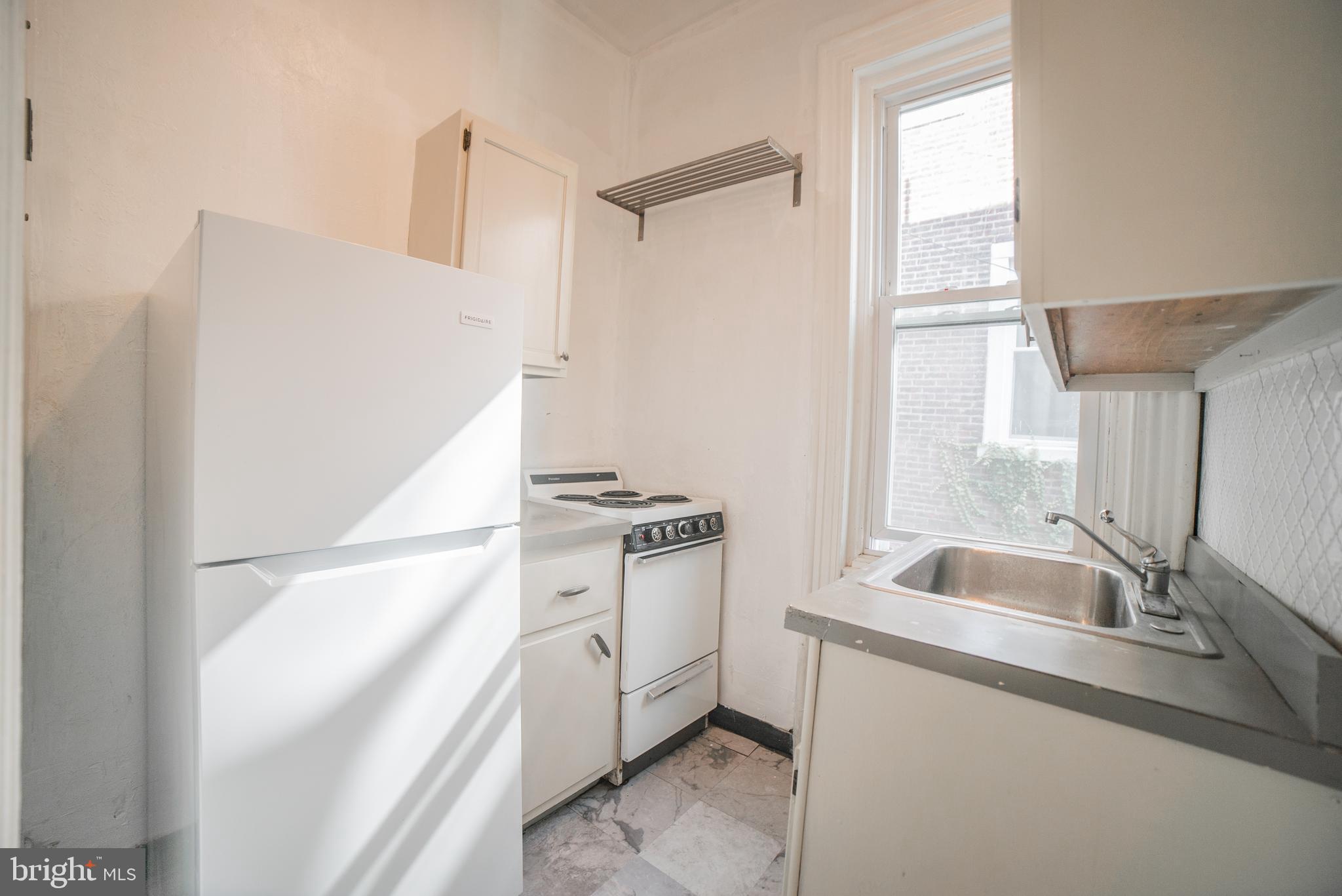 2316 Spruce Street, Unit 2R Philadelphia, PA 19103 - Photo 2 of 11 a kitchen with a sink and a refrigerator