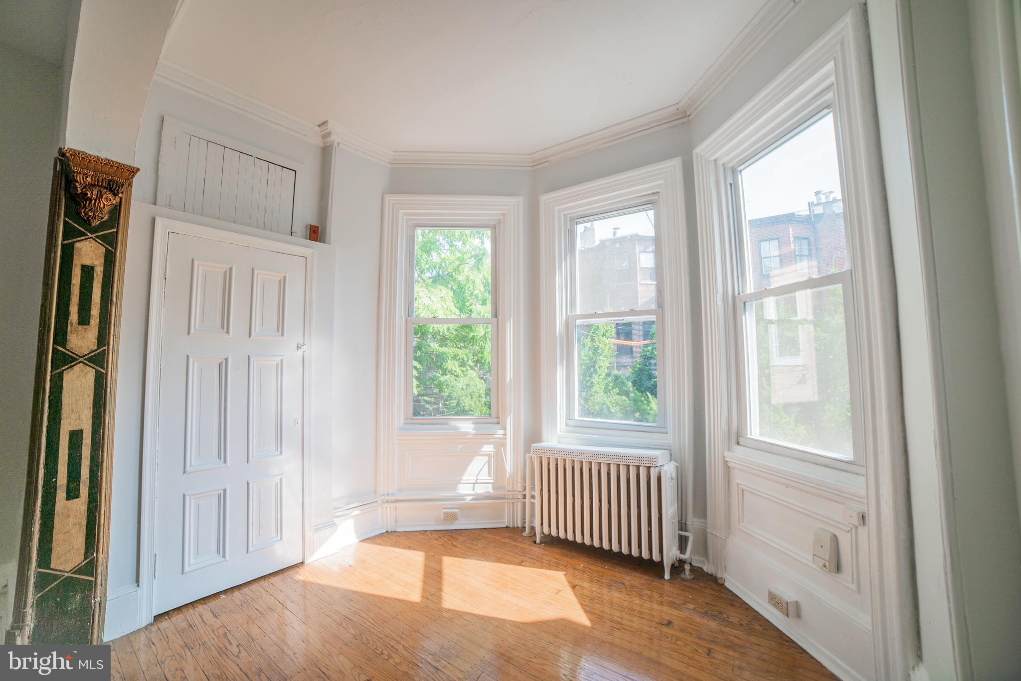 2316 Spruce Street, Unit 2R Philadelphia, PA 19103 - Photo 8 of 11 a view of a bedroom with wooden floor and windows