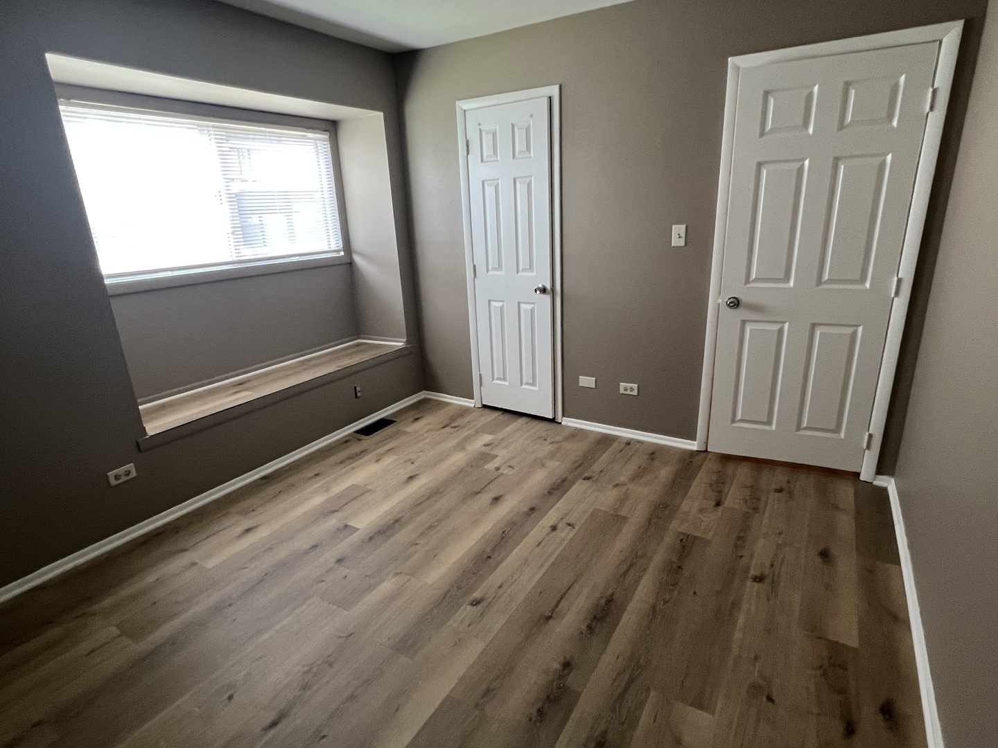 2664 Woodview Court, Unit 2664 Waukegan, IL 60087 - Photo 2 of 6 a view of an empty room with wooden floor and a window