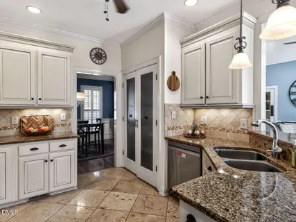 a kitchen with stainless steel appliances granite countertop a stove a refrigerator and a cabinets