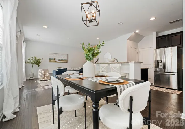 a view of a dining room with furniture and a chandelier