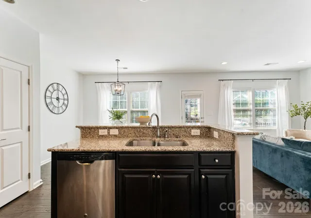 a kitchen with granite countertop a sink and a cabinets