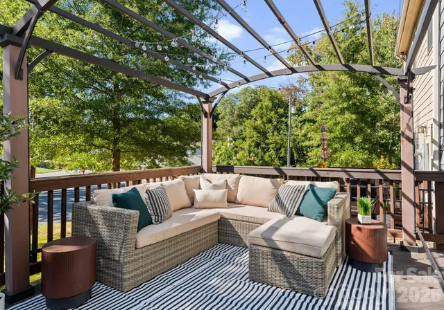 a balcony with wooden floor and outdoor seating