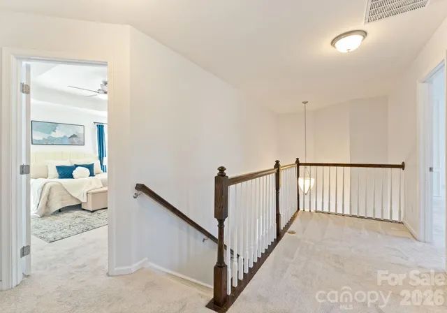 a view of a bedroom with wooden floor and furniture