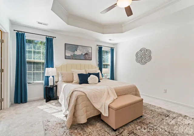 a bedroom with a bed couch and window