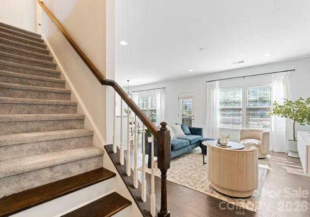 a living room with wooden floor and a large window