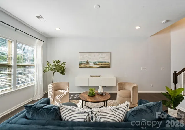 a living room with furniture and a potted plant