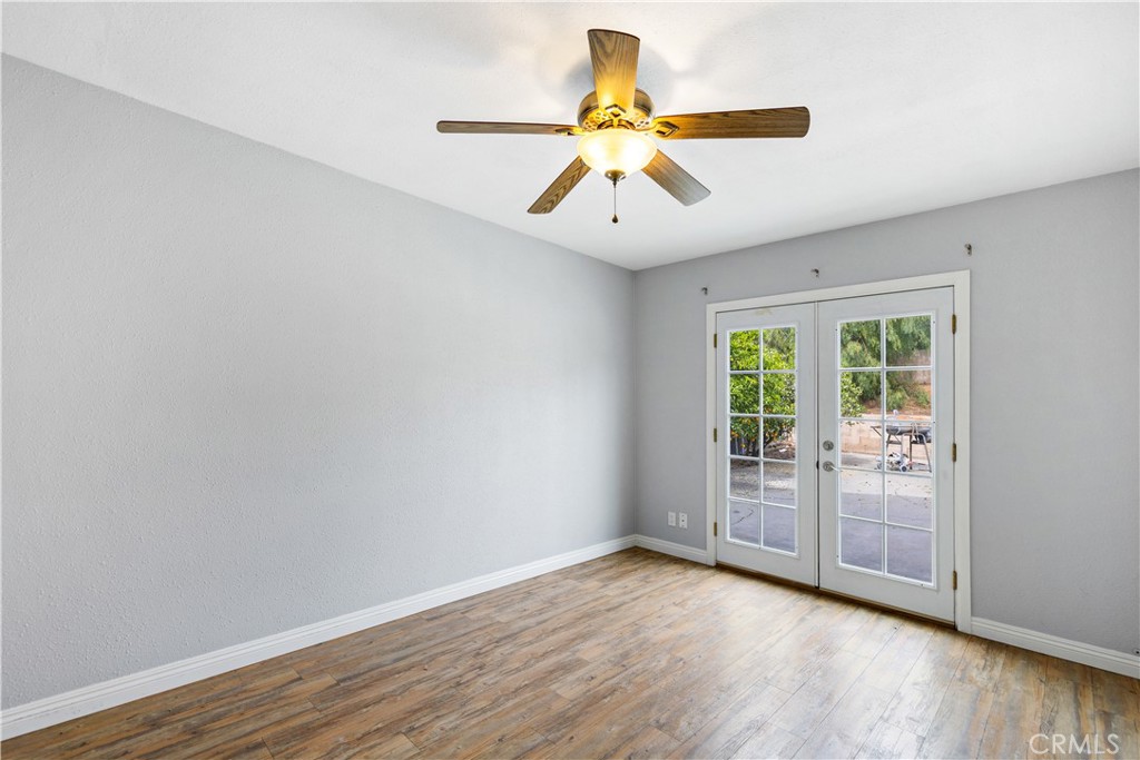461 West Blaine Street Riverside, CA 92507 - Photo 13 of 22 an empty room with wooden floor fan and windows