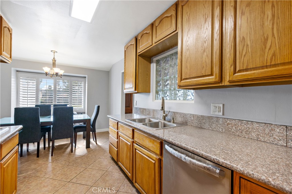 461 West Blaine Street Riverside, CA 92507 - Photo 8 of 22 a kitchen with stainless steel appliances granite countertop a sink and a cabinets