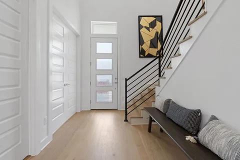 a view of an entryway with wooden floor
