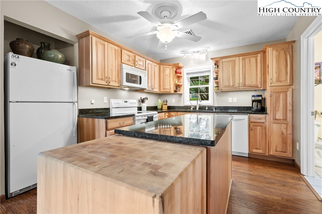 17 Elderberry Loop Newland, NC 28657 - Photo 15 of 47 a kitchen with stainless steel appliances granite countertop a sink a stove a refrigerator a center island and a window