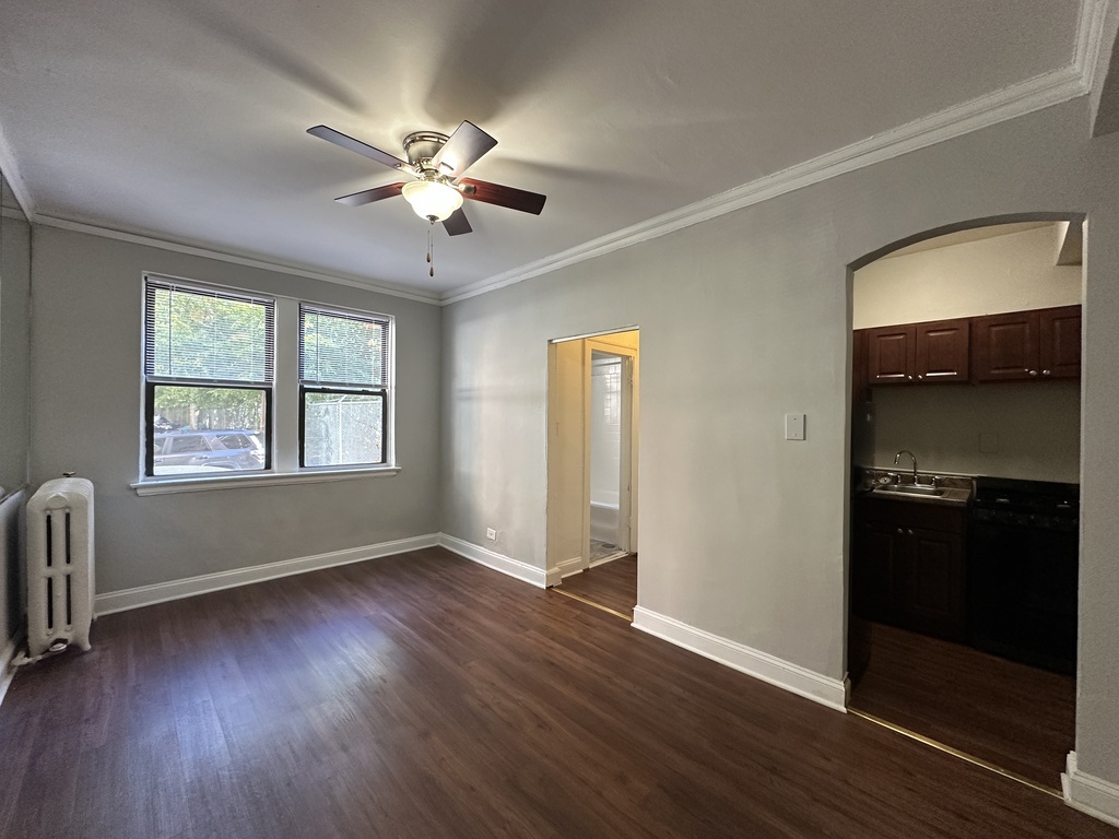 661 West Sheridan Road, Unit 503 Chicago, IL 60613 - Photo 9 of 20 wooden floor in an empty room with a window