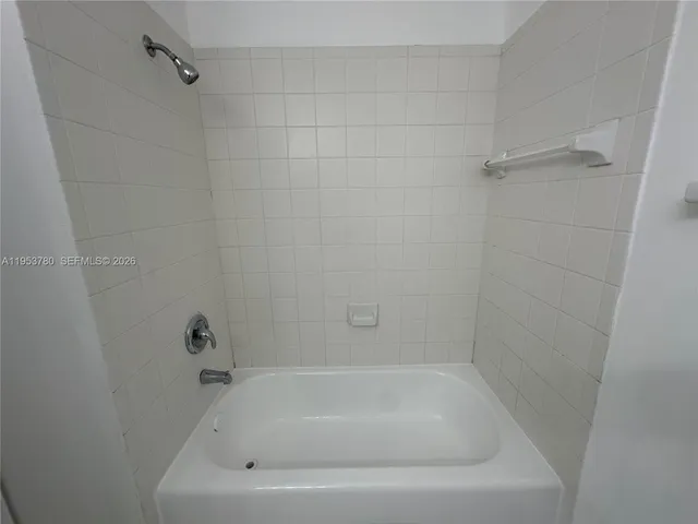 a white bath tub sitting in a bathroom