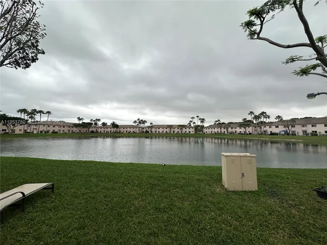 a view of a lake with houses in the back