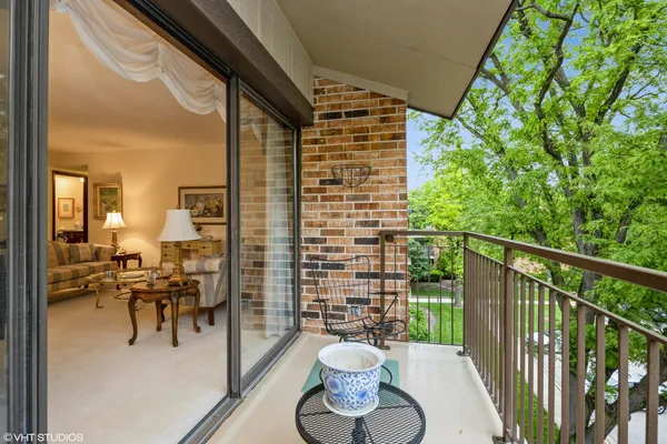 a balcony with table and chairs
