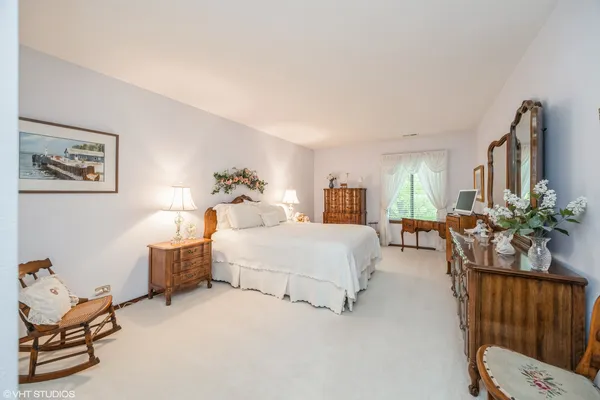 a bed room with furniture and a chair