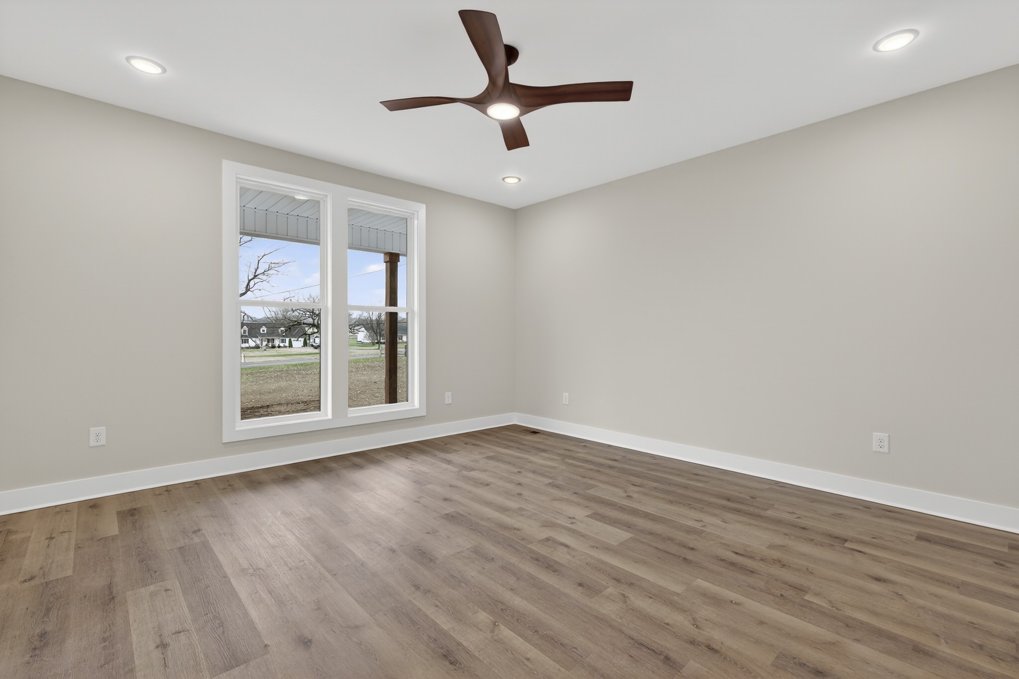 777 Rock Springs Road Castalian Springs, TN 37031 - Photo 21 of 56 a view of an empty room with a window and wooden floor