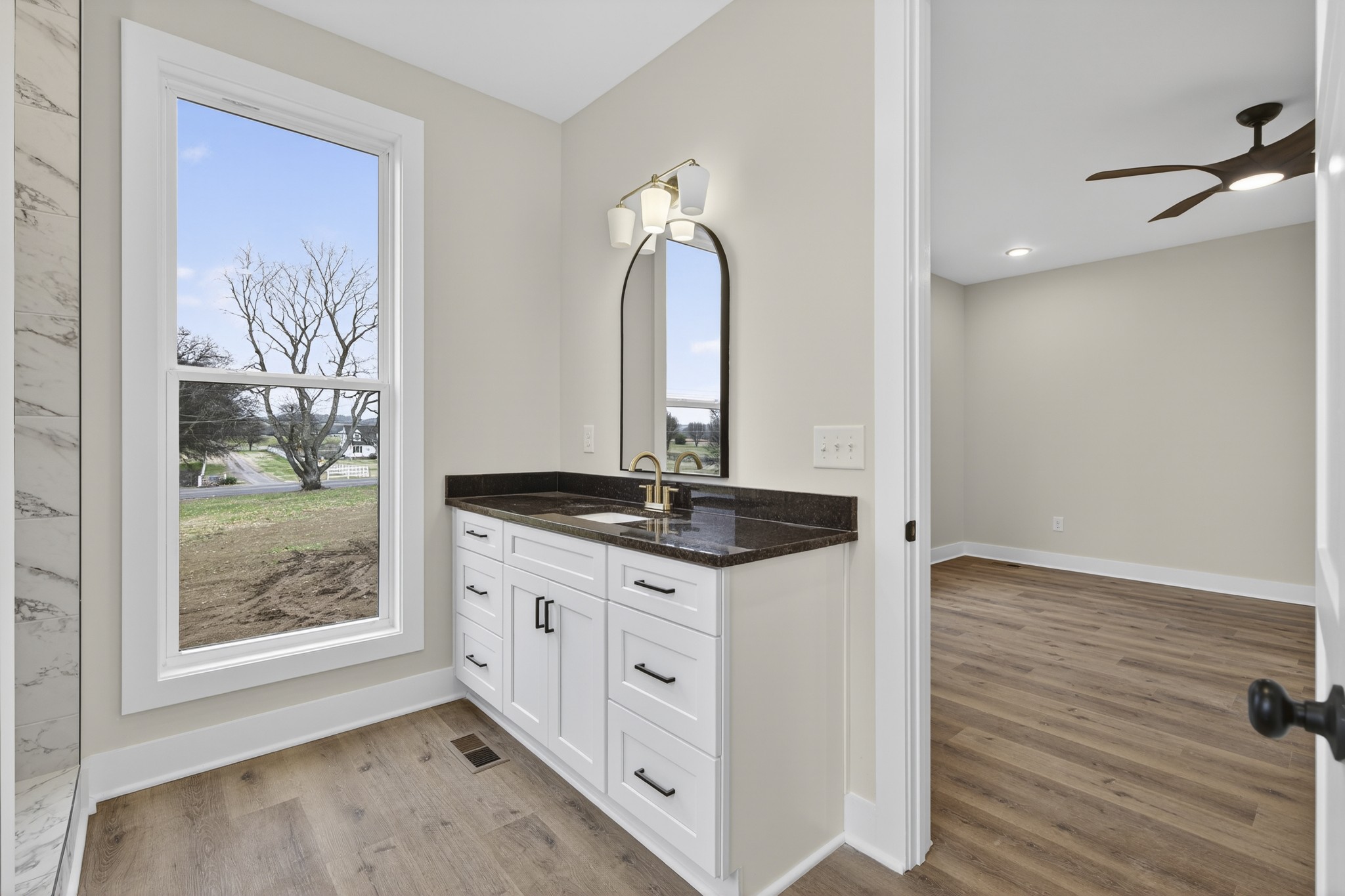 777 Rock Springs Road Castalian Springs, TN 37031 - Photo 23 of 56 a bathroom with a granite countertop sink a light fixture and a mirror