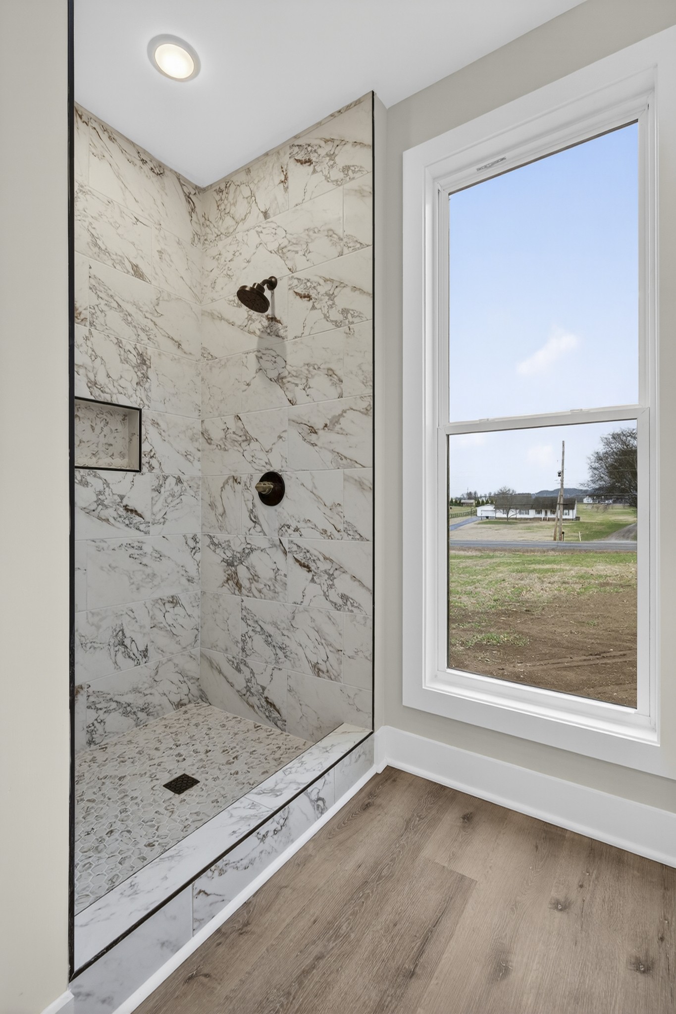 777 Rock Springs Road Castalian Springs, TN 37031 - Photo 24 of 56 a bathroom with a glass shower door and a window