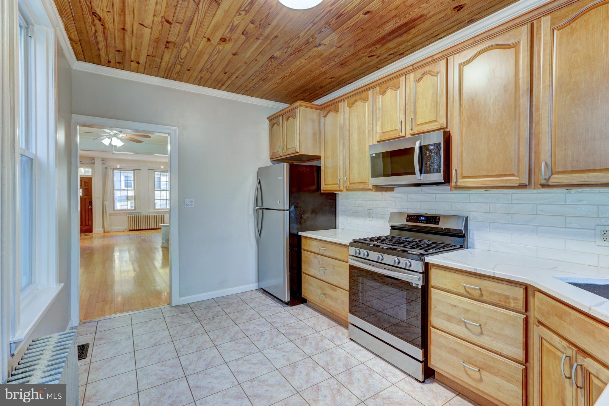 112 Vassar Street Philadelphia, PA 19128 - Photo 12 of 33 a kitchen with stainless steel appliances granite countertop a stove and a refrigerator