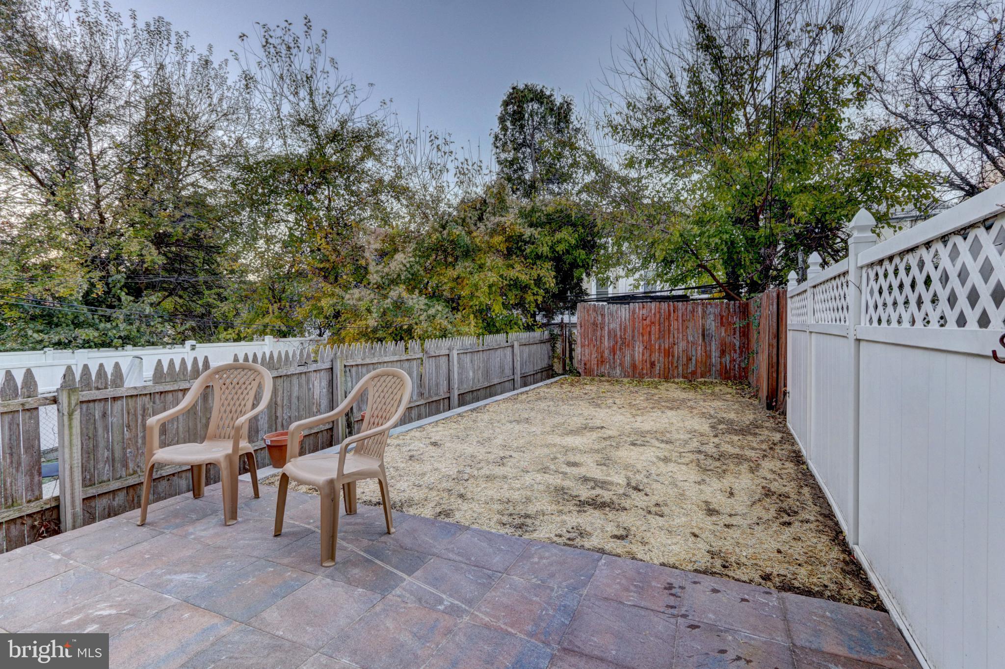 112 Vassar Street Philadelphia, PA 19128 - Photo 15 of 33 a view of a backyard with wooden fence and a bench
