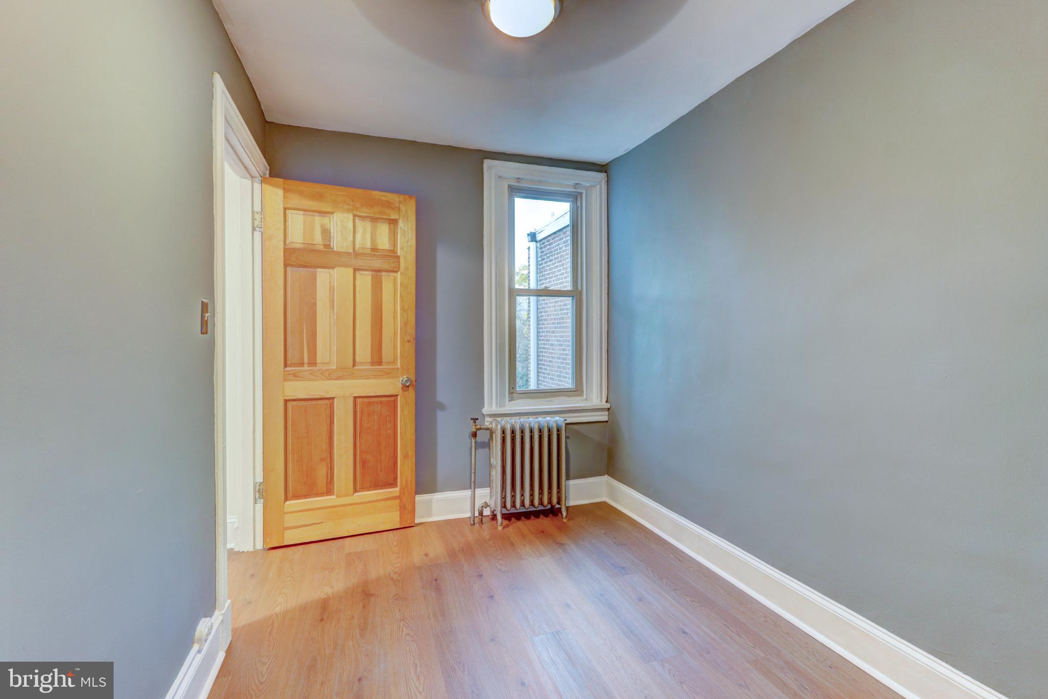 112 Vassar Street Philadelphia, PA 19128 - Photo 23 of 33 an empty room with wooden floor and windows