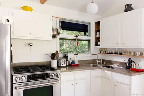 a kitchen with a stove a sink and a microwave