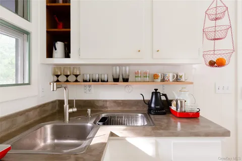 a kitchen with a sink and a potted plant next to a window