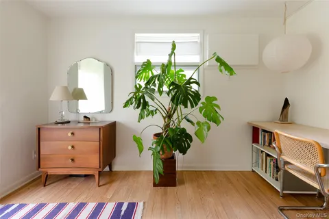a view of hallway with a large mirror and a shower