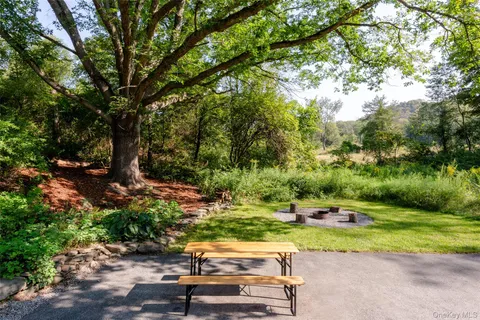 a view of a yard with cars parked on the road