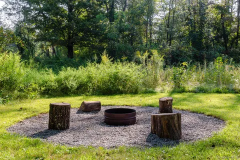 a green field with some trees in the background