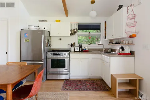 a kitchen with a appliances cabinets and a counter top space
