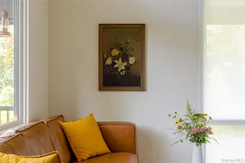 a blue plant sitting in a bedroom next to a window
